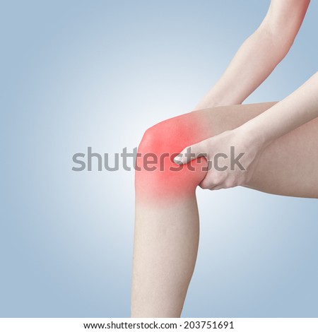 Acute pain in a woman knee. Medical concept photo.