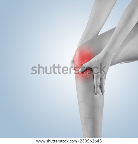 Woman with both palm around knee cap to show pain and injury on knee area.