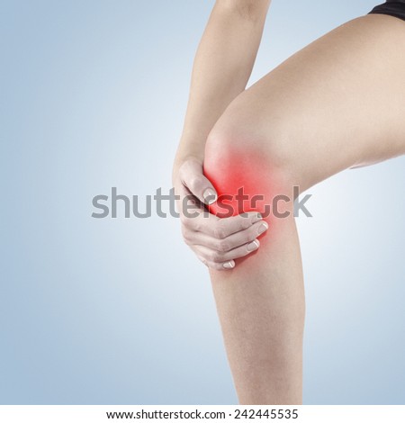 Pain in woman knee. Female holding hands on spot knee pain.