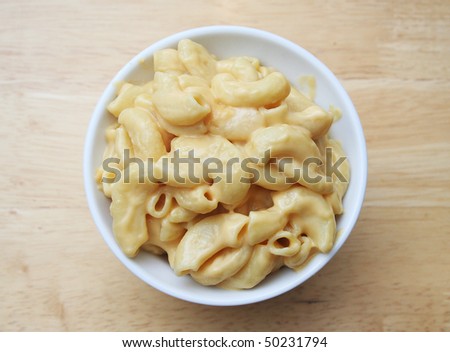 Macaroni and Cheese in a white bowl on a butcher block table