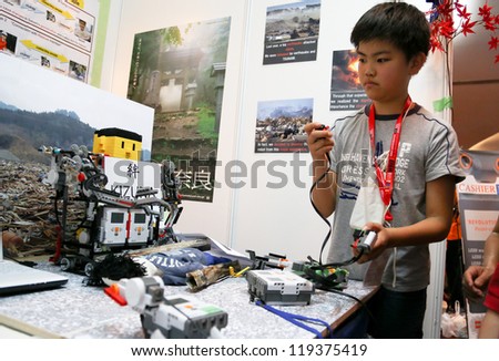 SUBANG JAYA - NOVEMBER 10: An unidentified students from Japan tests his remote control robot made to access dangerous areas at the World Robot Olympaid on November 10, 2012 in Subang Jaya, Malaysia.