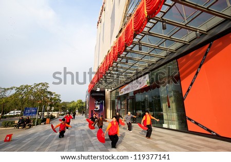 BEIJING - OCTOBER 14: Elderly women practice fan dance outside a shopping mall on October 14, 2012 in Beijing, China. Healthy living is promoted here as medical and healthcare cost escalates.