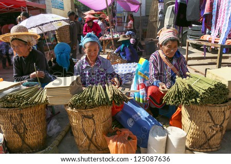 LAOMENG - DECEMBER 16: Traders wait for customers at a market in Lao Meng, China on December 16, 2012. People from 13 tribes/ethnic groups from China and Laos congregate here to trade daily.