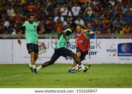 KUALA LUMPUR - AUGUST 9: FC Barcelona\'s players practice dribbling during training at Bukit Jalil National Stadium on August 9, 2013 in Malaysia.