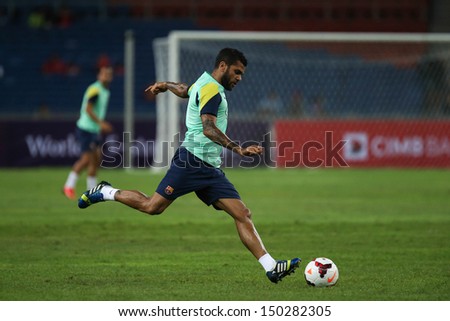 KUALA LUMPUR - AUGUST 9: FC Barcelona Dani Alves kicks the ball during training at the Bukit Jalil Stadium on August 09, 2013 in Malaysia. FC Barcelona is on an Asia Tour to Malaysia and Thailand.