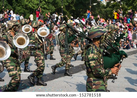 KUALA LUMPUR - AUGUST 31: Drums and brass band from the Malaysian Armed Forces march on the city streets celebrating Malaysia\'s Independence Day on August 31, 2013 in Kuala Lumpur, Malaysia.