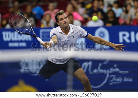 KUALA LUMPUR - SEPTEMBER 28: Julien Benneteau volleys a return to Stanilas Wawrinka in a semi-final match of the Malaysia Open 2013 tennis played at the Putra Stadium, Malaysia on September 28, 2013.
