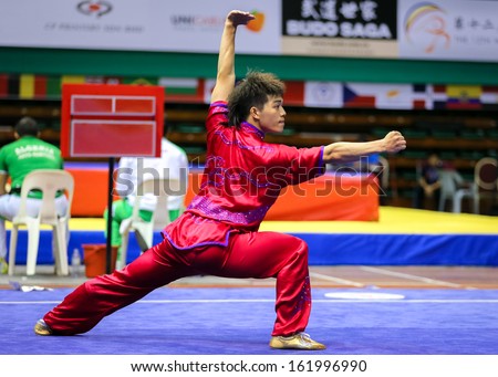 KUALA LUMPUR - NOV 03: Wu Nok In of Macau shows his fighting style in the \'changquan compulsory\' event at the 12th World Wushu Championship on November 03, 2013 in Kuala Lumpur, Malaysia.