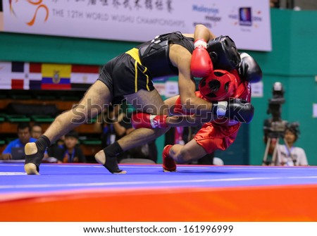 KUALA LUMPUR - NOV 03: Armenia\'s Karapet Tevosyan (black) tries to take down Philippines\' Jean Saclag in the Sanda event, 12th World Wushu Championship on November 03, 2013 in Kuala Lumpur, Malaysia.