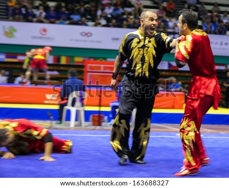 KUALA LUMPUR - NOV 05: Members of Iran\'s dalian team performs a fight scene in the Men\'s Dual Event at the 12th World Wushu Championship on November 05, 2013 in Kuala Lumpur, Malaysia.