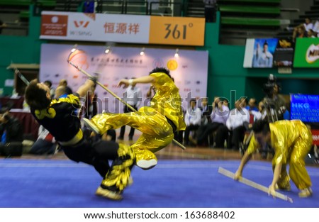KUALA LUMPUR - NOV 05: Hong Kong's dalian team performs a fight scene in the Men's Dual Event at the 12th World Wushu Championship on November 05, 2013 in Kuala Lumpur, Malaysia.