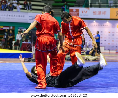 KUALA LUMPUR - NOV 05: Members of India\'s dalian team performs a fight scene in the Men\'s Dual Event at the 12th World Wushu Championship on November 05, 2013 in Kuala Lumpur, Malaysia.
