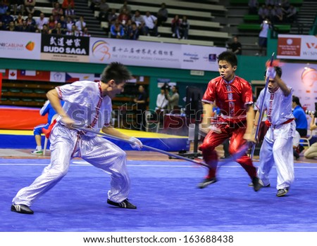 KUALA LUMPUR - NOV 05: Members of Philippine\'s dalian team performs a fight scene in the Men\'s Dual Event at the 12th World Wushu Championship on November 05, 2013 in Kuala Lumpur, Malaysia.