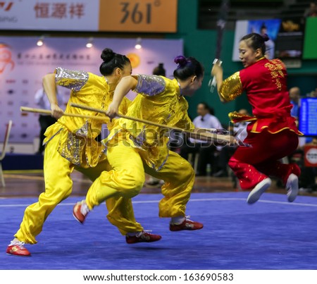 KUALA LUMPUR - NOV 05: Members of Macau's dalian team performs a fight scene in the Women's Dual Event at the 12th World Wushu Championship on November 05, 2013 in Kuala Lumpur, Malaysia.