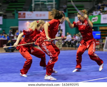 KUALA LUMPUR - NOV 05: Members of Ukraine's dalian team performs a fight scene in the Women's Dual Event at the 12th World Wushu Championship on November 05, 2013 in Kuala Lumpur, Malaysia.