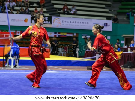 KUALA LUMPUR - NOV 05: Members of Ukraine\'s dalian team performs a fight scene in the Women\'s Dual Event at the 12th World Wushu Championship on November 05, 2013 in Kuala Lumpur, Malaysia.
