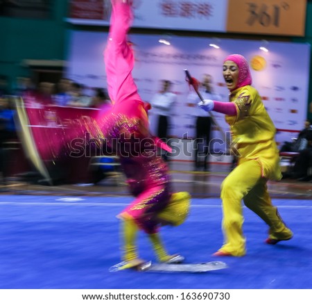 KUALA LUMPUR - NOV 05: Members of the Iranian dalian team performs a fight scene in the Women\'s Dual Event at the 12th World Wushu Championship on November 05, 2013 in Kuala Lumpur, Malaysia.