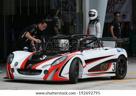 SEPANG, MALAYSIA - MAY 10, 2014: The race car of CM Wong undergoes check during the pit-stop at the free practice session of the Malaysian Super Series Round 2 in Sepang International Circuit.