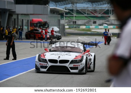 SEPANG, MALAYSIA - MAY 10, 2014: The BMW car of drivers Jun San Chen and Ollie Millroy returns to the pit lane after the free practice session of the Malaysian Super Series Round 2 in Sepang Circuit.