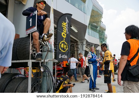 SEPANG, MALAYSIA - MAY 11, 2014: The team mechanics and pit crew wait at the pit lane preparing for the next race at the Thailand Super Series Round 1 held in Sepang International Circuit, Malaysia.