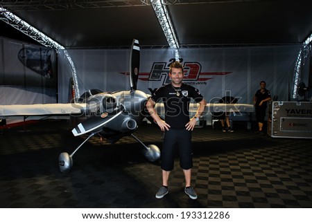 PUTRAJAYA, MALAYSIA - MAY 17, 2014: World champion Hannes Arch from Austria poses with his Edge 540 v3 plane in his hangar at the Red Bull Air Race World Championship 2014 in Putrajaya, Malaysia.