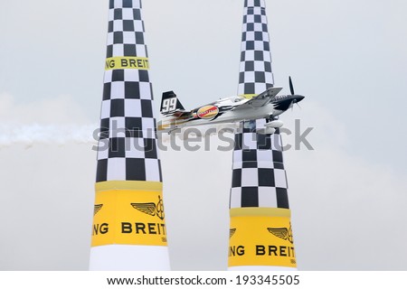 PUTRAJAYA, MALAYSIA - MAY 17, 2014: Michael Goulian of USA, in an Edge 540 V2 plane flies past the pylons at the qualifying session of the Red Bull Air Race World Championship 2014.