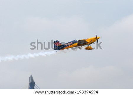 PUTRAJAYA, MALAYSIA - MAY 17, 2014: Matt Hall from Australia in a MXS-R plane flies in the skies of Putrajaya, Malaysia during the qualifying session of the Red Bull Air Race World Championship 2014.