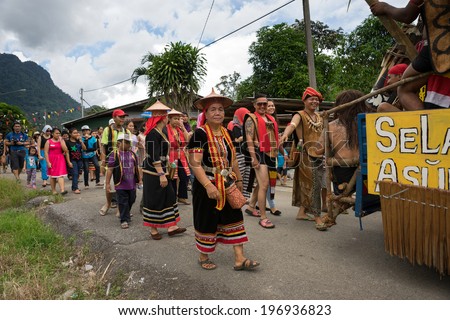 SARAWAK, MALAYSIA: JUNE 1, 2014: People of the Bidayuh tribe, an indigenous native people of Borneo, in traditional costumes, take part in a street parade to celebrate the Gawai Dayak festival.
