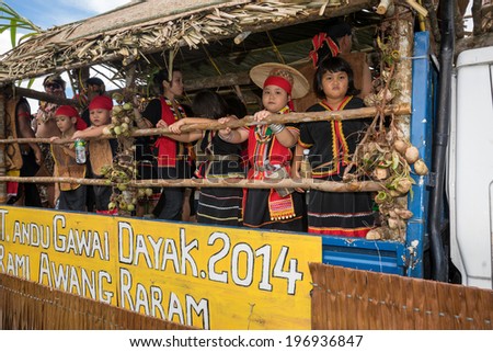 SARAWAK, MALAYSIA: JUNE 1, 2014: People of the Bidayuh tribe, an indigenous native people of Borneo, take part in a street parade on board a lorry, celebrating the Gawai Dayak festival.