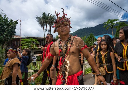 SARAWAK, MALAYSIA: JUNE 1, 2014: People of the Bidayuh tribe, an indigenous native people of Borneo, in traditional costumes, take part in a street parade to celebrate the Gawai Dayak festival.