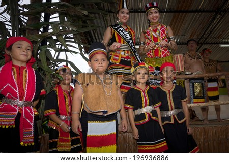 SARAWAK, MALAYSIA: JUNE 1, 2014: Children from the Bidayuh tribe, an indigenous native people of Borneo poses with the beauty pageant winners, celebrating thanksgiving day known as the Gawai festival.