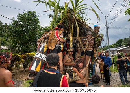 SARAWAK, MALAYSIA: JUNE 1, 2014: Musicians from the Bidayuh tribe, an indigenous native people of Borneo plays the drums in a street parade celebrating thanksgiving day, known as the Gawai festival.