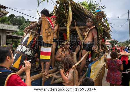 SARAWAK, MALAYSIA: JUNE 1, 2014: Musicians from the Bidayuh tribe, an indigenous native people of Borneo plays the drums in a street parade celebrating thanksgiving day, known as the Gawai festival.