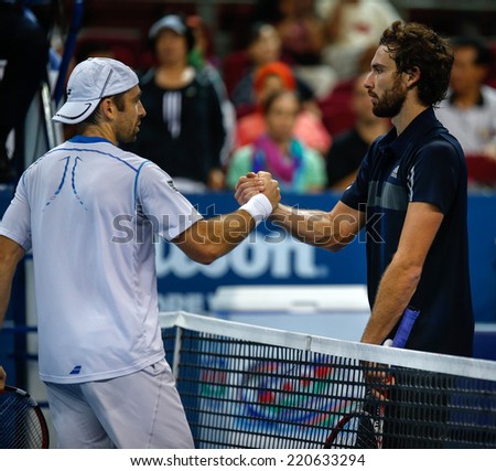 SEPTEMBER 26, 2014 - KUALA LUMPUR, MALAYSIA: Benjamin Becker (white) shakes Ernests Gulbis\' hands after their match at the Malaysian Open Tennis 2014. This event is an ATP sanctioned tournament.