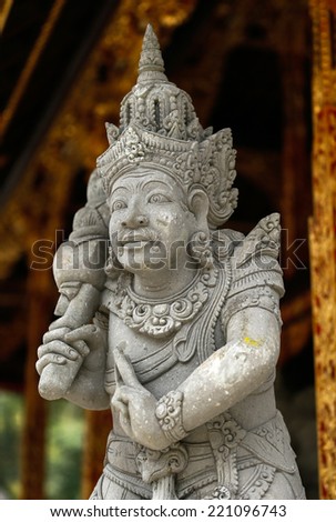 Stone sculpture of Balinese Hindu god inside the Tirta Empul Temple.