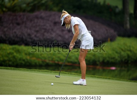 KUALA LUMPUR, MALAYSIA - OCTOBER 10, 2014: Natalie Gulbis of the USA putts the ball to the 18th hole of the KL Golf & Country Club at the 2014 Sime Darby LPGA Malaysia golf tournament.