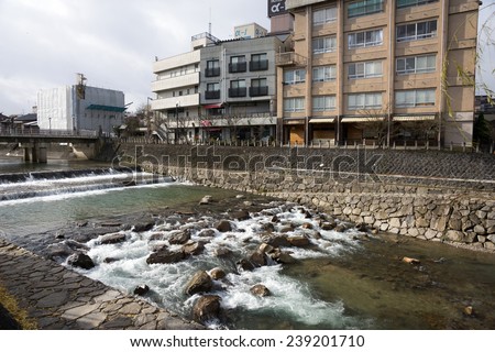 TAKAYAMA, JAPAN - DECEMBER 3, 2014: Low rise buildings and clean river is a common cityscape find in Japan. Strong environmental laws keeps the nation clean and green.