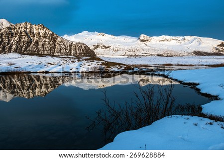 ICELAND - MARCH 28, 2015: The last light falls on the white snow covered flat summit of the highest summit at the Vatnajokull National Park. The scenic landscapes is a tourist attraction.