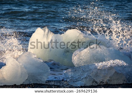 Blocks of ice from the glaciers break up and is washed ashore by the strong waves of the North Atlantic sea in Iceland.