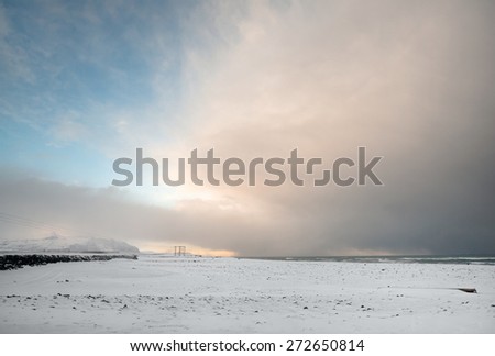 View of snow covered mountains, plains and beaches in southern Iceland during a winter morning.