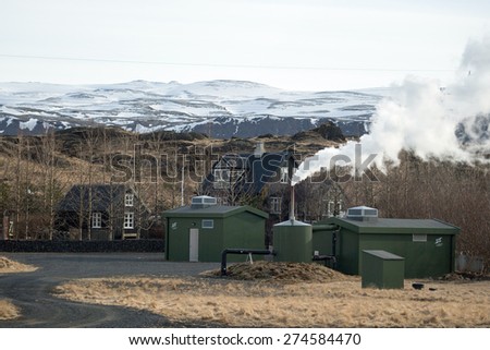 ICELAND - MARCH 25, 2015: A farm utilizes geothermal energy to generate electricity for domestic use. Non-polluting steam is released as a by-product and is environmental friendly.