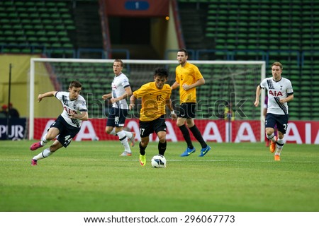 May 27, 2015 - Shah Alam, Malaysia: Malaysia\'s Joseph Kalang (17) dribbles the ball past Tottenham Hotspur\'s defenders in a friendly match in Malaysia. Tottenham Hotspur is on a Asia-Australia tour.