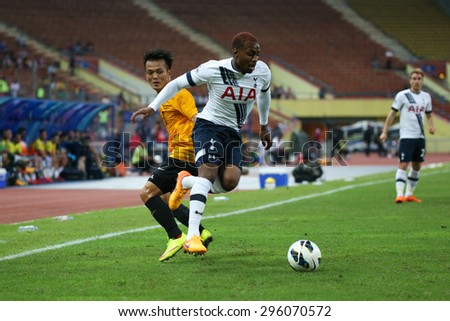 May 27, 2015- Shah Alam, Malaysia: Tottenham Hotspur\'s Danny Rose (white) fights for the ball with Malaysia\'s Joseph Kalang (orange) in a friendly match. Tottenham Hotspur is on a Asia-Australia tour.