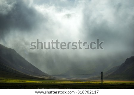 rain clouds over valley and farm in Iceland