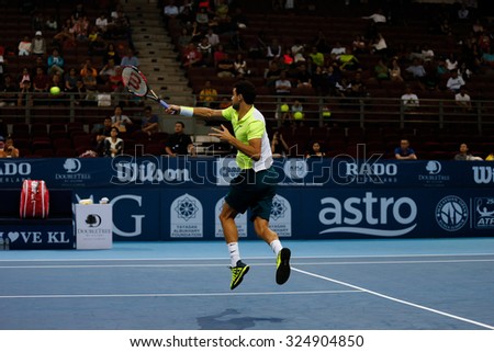 KUALA LUMPUR, MALAYSIA - OCTOBER 01, 2015:Grigor Dimitrov of Bulgaria hits a forehand volley in his match at the Malaysian Open 2015 Tennis tournament held at the Putra Stadium, Malaysia.