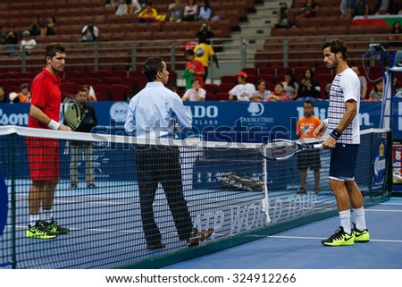 KUALA LUMPUR, MALAYSIA - OCTOBER 01, 2015: Mischa Zverev (red) and Feliciano Lopez waits for the coin toss to start their match at the Malaysian Open 2015 Tennis tournament held at the Putra Stadium.