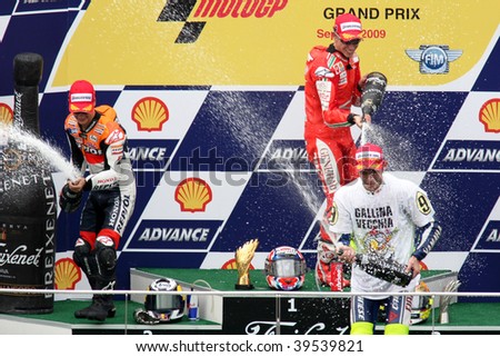 SEPANG, MALAYSIA - OCTOBER 25: Winners of the MotoGP race celebrating on the podium at the 2009 Shell Advance Malaysian Motorcycle GP. October 25, 2009 in Malaysia.