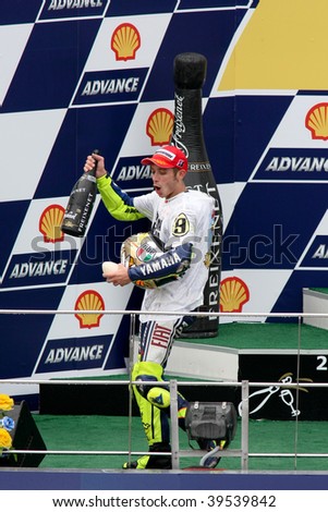 SEPANG, MALAYSIA - OCTOBER 25: Newly crowned MotoGP world champion Valentino Rossi celebrating on the podium at the 2009 Shell Advance Malaysian Motorcycle GP. October 25, 2009 in Malaysia.