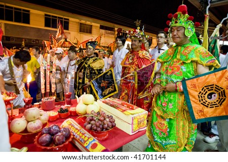 MALACCA - OCTOBER 31: A street parade with men dressed as emperor gods and skewered in the cheeks, in a Taoism prayer ceremony in Malacca.  October 31, 2009 in Malaysia