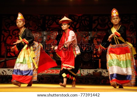 KUCHING, MALAYSIA - MAY 14: Artists from the indigenous Bidayuh people perform a traditional dance at the Sarawak Cultural Village, May14, 2010 in Kuching. The Bidayuh are gentle and friendly natives from Borneo.